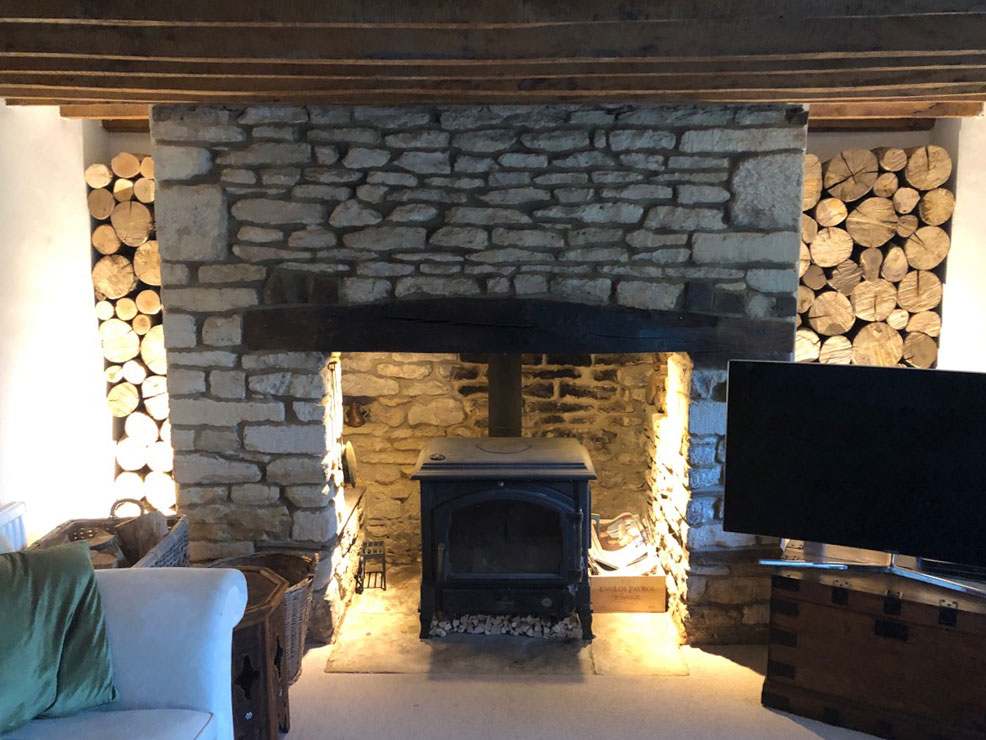 decorative hardwood logs in a fireplace alcove